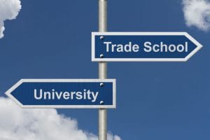 Deciding on whether to go to University or Trade School, Two Blue Road Sign with text University and Trade School with sky background