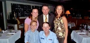 Proud husband and father Brad Henry enjoys dinner out with his family. Pictured back row from left to right: Oldest daughter Stephanie Slusher, son-in-law Brad Slusher, and his wife Denise. Pictured front row from left to right: Brad’s oldest grandson Jayton and his youngest daughter Katelyn.