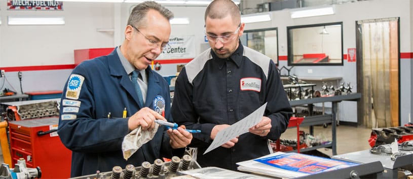 IntelliTec College Automotive instructor is teaching a student one-on-one