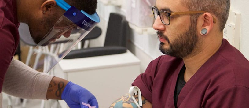 IntelliTec College Medical Assistant students practice administering a needle