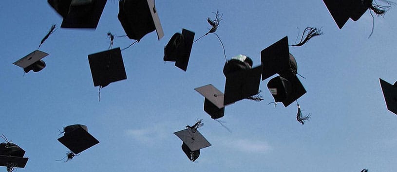 Graduation caps in the air